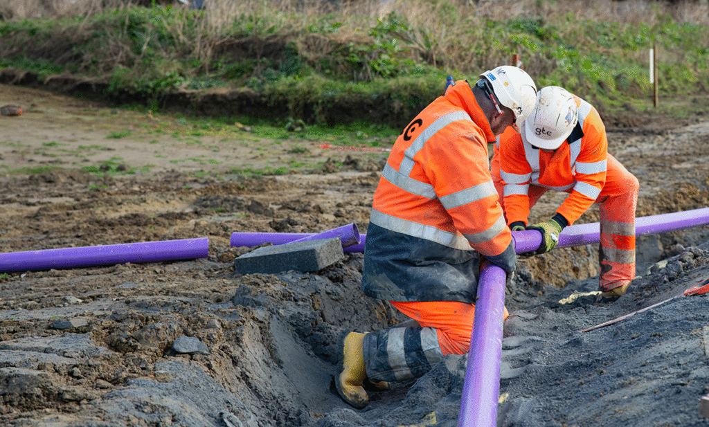 Two GTC engineers installing full fibre network cables onsite in a housing development