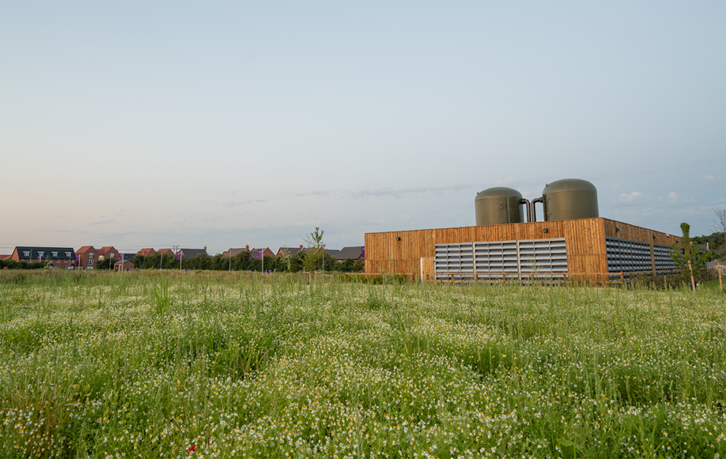 A view across grassland at the GTC community air source heat network hub
